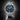 A stainless steel wristwatch with a blue dial, black bezel, and silver link bracelet.