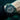 Black wristwatch with a detailed face on a person's wrist underwater
