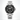 A stainless steel wristwatch with a carbon dial and black rotating bezel, featuring silver-tone hour markers and hands, a date window at 3 o'clock, and a matching steel link bracelet. 