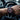 Person wearing a black and red watch inside a car