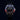 Wristwatch with a black, red, and blue dial on a dark background