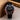 Wristwatch with black strap and red and blue bezel on a neutral background