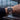 Person wearing a watch with a cityscape view through large windows