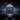 Silver watch with a blue face on a dark background