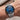Wrist wearing a Contardi watch with a blue dial and silver bracelet.