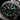 Close-up of a Contrama watch with a black dial and green hour markers.