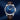 Luxury watch with blue dial and brown leather strap on a dark blue background