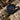 Watch with a green strap on a rocky surface