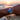 Person wearing a watch with a sunset and beach in the background