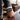 Person wearing a watch on a wooden table with a blurred background