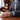 Man in a suit with a watch on his wrist in an office setting