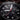 Close-up of a black watch with detailed design and visible brand name.