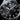 Black watch with silver accents and 'Contrarian' branding on a dark background